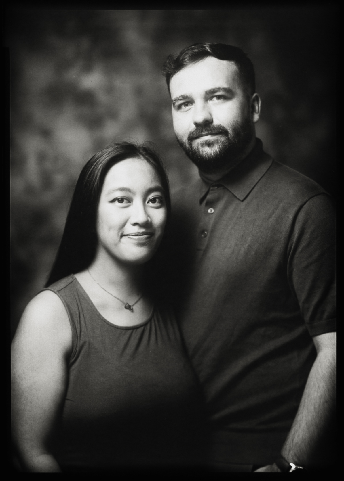 Black and white 5×7 large format couple portrait, a smiling woman and a bearded man, shot on a 1950s camera